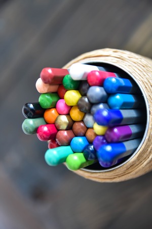 colored pencils on a wooden brown backgroundの写真素材