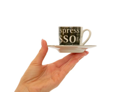 Woman's hand holding espresso coffee cup