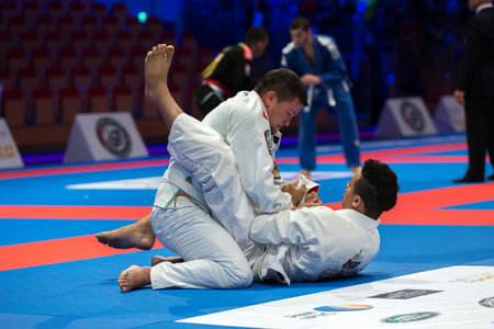 ABU DHABI, UAE - APRIL 19, 2016: ABU DHABI WORLD PROFESSIONAL JIU-JITSU CHAMPIONSHIP 2016 in the IPIC ARENA. Fighters fight on the mat.のeditorial素材