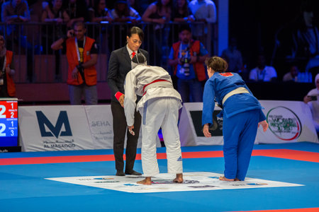 ABU DHABI, UAE - APRIL 19, 2016: ABU DHABI WORLD PROFESSIONAL JIU-JITSU CHAMPIONSHIP 2016 in the IPIC ARENA. Fighters bow down to the referee.のeditorial素材