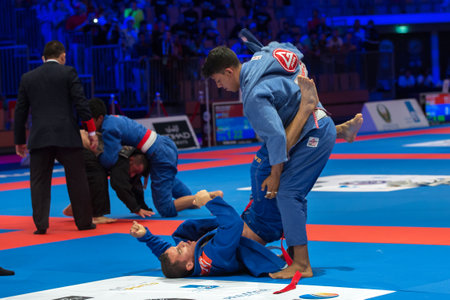 ABU DHABI, UAE - APRIL 19, 2016: ABU DHABI WORLD PROFESSIONAL JIU-JITSU CHAMPIONSHIP 2016 in the IPIC ARENA. Fighters with white belts fighting on the mat.のeditorial素材
