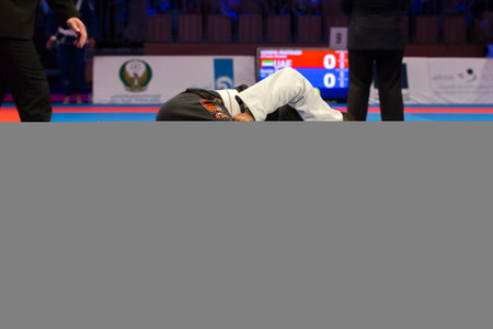 ABU DHABI, UAE - APRIL 19, 2016: ABU DHABI WORLD PROFESSIONAL JIU-JITSU CHAMPIONSHIP 2016 in the IPIC ARENA. Men in white and black kimonos fighting in the parterre.のeditorial素材