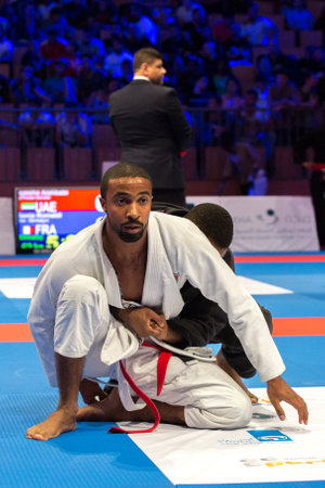 ABU DHABI, UAE - APRIL 19, 2016: ABU DHABI WORLD PROFESSIONAL JIU-JITSU CHAMPIONSHIP 2016 in the IPIC ARENA. Men in white and black kimonos fighting in the parterre.のeditorial素材