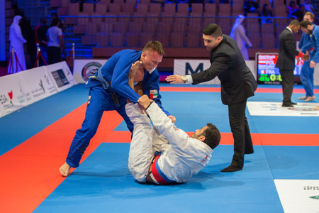 ABU DHABI, UAE - APRIL 19, 2016: ABU DHABI WORLD PROFESSIONAL JIU-JITSU CHAMPIONSHIP 2016 in the IPIC ARENA. Fighters fight on the mat.のeditorial素材