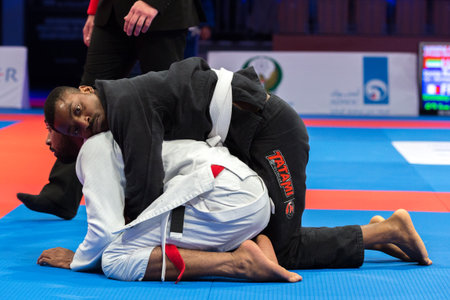 ABU DHABI, UAE - APRIL 19, 2016: ABU DHABI WORLD PROFESSIONAL JIU-JITSU CHAMPIONSHIP 2016 in the IPIC ARENA. Men in white and black kimonos fighting in the parterre.のeditorial素材
