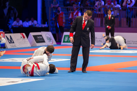 ABU DHABI, UAE - APRIL 19, 2016: ABU DHABI WORLD PROFESSIONAL JIU-JITSU CHAMPIONSHIP 2016 in the IPIC ARENA. Fighters fighting on the mat.のeditorial素材