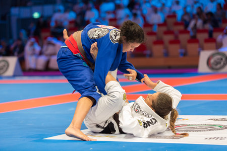 ABU DHABI, UAE - APRIL 19, 2016: ABU DHABI WORLD PROFESSIONAL JIU-JITSU CHAMPIONSHIP 2016 in the IPIC ARENA. Female fighters in the parterre in battle.のeditorial素材