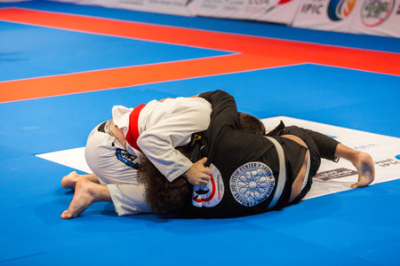 ABU DHABI, UAE - APRIL 19, 2016: ABU DHABI WORLD PROFESSIONAL JIU-JITSU CHAMPIONSHIP 2016 in the IPIC ARENA. Fighters in black and white kimono on the floor.のeditorial素材