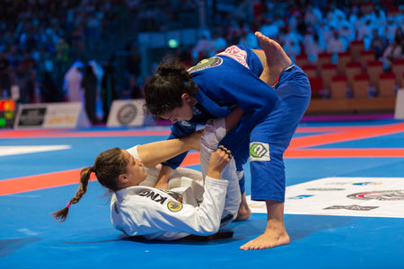 ABU DHABI, UAE - APRIL 19, 2016: ABU DHABI WORLD PROFESSIONAL JIU-JITSU CHAMPIONSHIP 2016 in the IPIC ARENA. Female fighters in the parterre.のeditorial素材