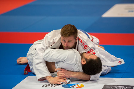 ABU DHABI, UAE - APRIL 19, 2016: ABU DHABI WORLD PROFESSIONAL JIU-JITSU CHAMPIONSHIP 2016 in the IPIC ARENA. Fighters with blue belts fighting in parterre.のeditorial素材