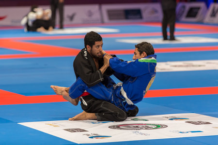 ABU DHABI, UAE - APRIL 19, 2016: ABU DHABI WORLD PROFESSIONAL JIU-JITSU CHAMPIONSHIP 2016 in the IPIC ARENA. Fighters sitting on the mat.のeditorial素材