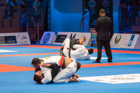 ABU DHABI, UAE - APRIL 19, 2016: ABU DHABI WORLD PROFESSIONAL JIU-JITSU CHAMPIONSHIP 2016 in the IPIC ARENA. Male fighters on the mat.のeditorial素材