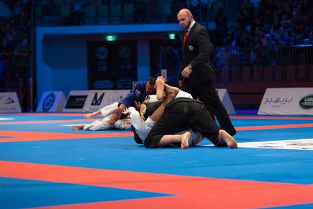 ABU DHABI, UAE - APRIL 19, 2016: ABU DHABI WORLD PROFESSIONAL JIU-JITSU CHAMPIONSHIP 2016 in the IPIC ARENA. Male fighters on the mat. Fighting.のeditorial素材