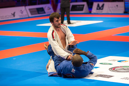 ABU DHABI, UAE - APRIL 19, 2016: ABU DHABI WORLD PROFESSIONAL JIU-JITSU CHAMPIONSHIP 2016 in the IPIC ARENA. Fighters on the mat.のeditorial素材