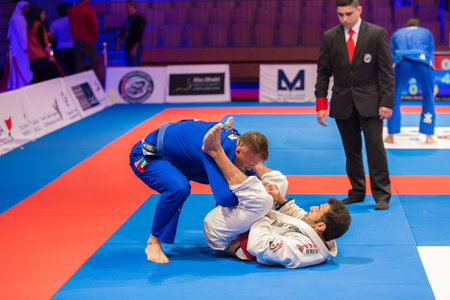 ABU DHABI, UAE - APRIL 19, 2016: ABU DHABI WORLD PROFESSIONAL JIU-JITSU CHAMPIONSHIP 2016 in the IPIC ARENA. Fighters on the mat.のeditorial素材