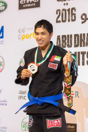 ABU DHABI, UAE - APRIL 19, 2016: ABU DHABI WORLD PROFESSIONAL JIU-JITSU CHAMPIONSHIP 2016 in the IPIC ARENA. UAE fighter with medal on the podium.のeditorial素材