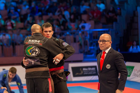 ABU DHABI, UAE - APRIL 19, 2016: ABU DHABI WORLD PROFESSIONAL JIU-JITSU CHAMPIONSHIP 2016 in the IPIC ARENA. Fighters hug each other.のeditorial素材
