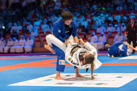 ABU DHABI, UAE - APRIL 19, 2016: ABU DHABI WORLD PROFESSIONAL JIU-JITSU CHAMPIONSHIP 2016 in the IPIC ARENA. Female fighters are fighting.のeditorial素材