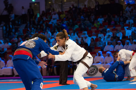 ABU DHABI, UAE - APRIL 19, 2016: ABU DHABI WORLD PROFESSIONAL JIU-JITSU CHAMPIONSHIP 2016 in the IPIC ARENA. Female fighters on the mat are fighting.のeditorial素材
