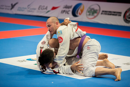 ABU DHABI, UAE - APRIL 19, 2016: ABU DHABI WORLD PROFESSIONAL JIU-JITSU CHAMPIONSHIP 2016 in the IPIC ARENA. Fighters with purple belts fighting in parterre.のeditorial素材