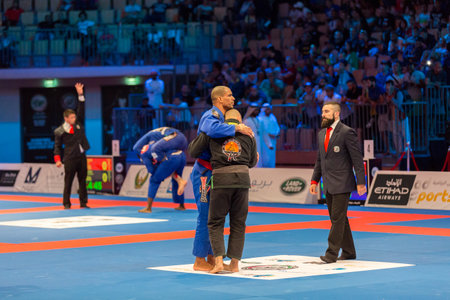 ABU DHABI, UAE - APRIL 19, 2016: ABU DHABI WORLD PROFESSIONAL JIU-JITSU CHAMPIONSHIP 2016 in the IPIC ARENA. Fighters hugging each other.のeditorial素材
