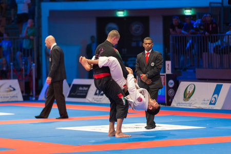 ABU DHABI, UAE - APRIL 19, 2016: ABU DHABI WORLD PROFESSIONAL JIU-JITSU CHAMPIONSHIP 2016 in the IPIC ARENA. Fighters with balck belts on the mat.のeditorial素材