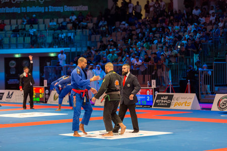 ABU DHABI, UAE - APRIL 19, 2016: ABU DHABI WORLD PROFESSIONAL JIU-JITSU CHAMPIONSHIP 2016 in the IPIC ARENA. Fighters are going to hug each other.のeditorial素材