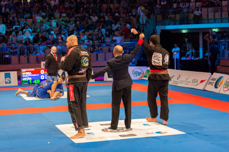ABU DHABI, UAE - APRIL 19, 2016: ABU DHABI WORLD PROFESSIONAL JIU-JITSU CHAMPIONSHIP 2016 in the IPIC ARENA. Fighters in black kimonos. Black view.のeditorial素材