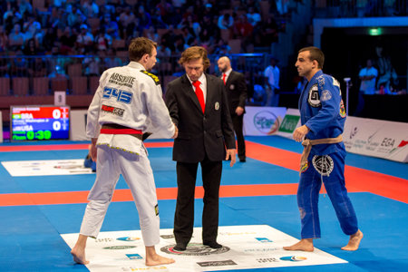ABU DHABI, UAE - APRIL 19, 2016: ABU DHABI WORLD PROFESSIONAL JIU-JITSU CHAMPIONSHIP 2016 in the IPIC ARENA. Fighter shacking hands with referee.のeditorial素材
