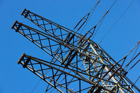 Metall high-voltage line support against the blue sky.の写真素材
