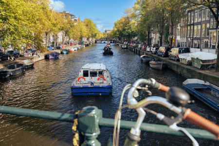 Boat sails along the canal in Amsterdam, Netherlands.の写真素材
