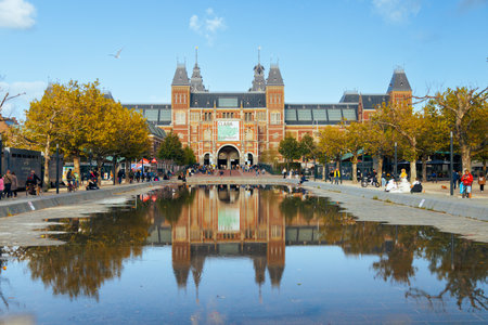 Amsterdam - 02 October 2022 - Famous Rijksmuseum in Amsterdam, Netherlands. There are a lot of tourists. Reflection on the autumn water.のeditorial素材