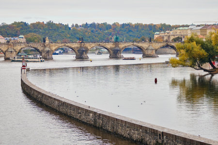 View of boat with famous Charles Bridge on background in autumn Prague.の写真素材