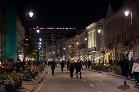 Night walking street with people in Warsaw, Poland.のeditorial素材