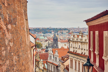 View of the Prague city between brick wall and the facades during autumn.の写真素材