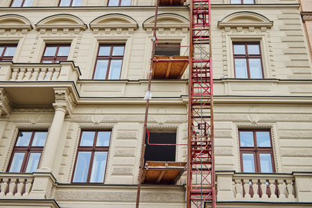 Facade of the beige historical building under reconstruction in Prague.の写真素材