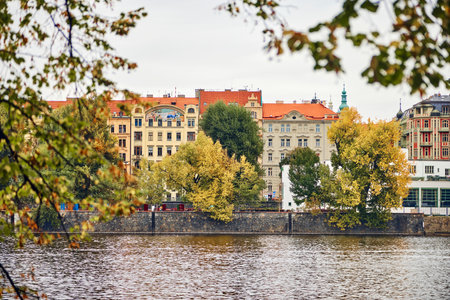 Autumn view of the old Prague embankment with historical buildings.の写真素材