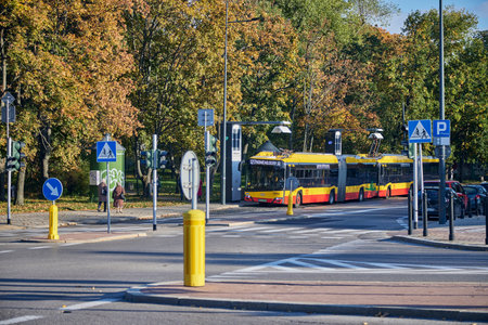 Modern trolley bus riding with passengers in the streets of Warsaw.のeditorial素材