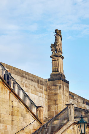 Statue on Charles Bridge in Prague against the sky.の写真素材
