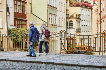 Elderly couple on the bridge near the Canal Certovka in Prague.の写真素材