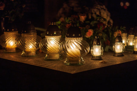 Lanterns on gravestone at night during All Saints day.の写真素材