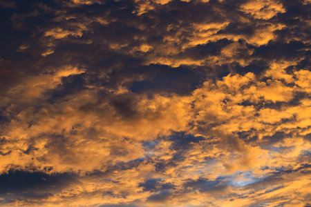 Beautiful orange dramatic sky with clouds at sunset or sunrise.の写真素材