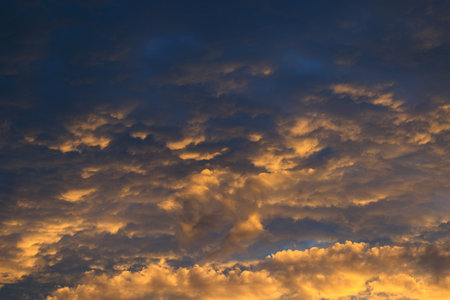 Dramatic sunrise against a sky with colorful clouds. Real sunset, dawn.