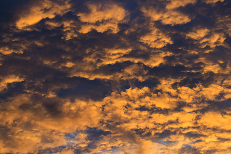 Dramatic sky at sunset with purple, yellow and orange colors.の写真素材