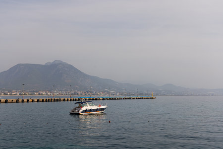 Pier in Alanya with anchored motor boat.の写真素材
