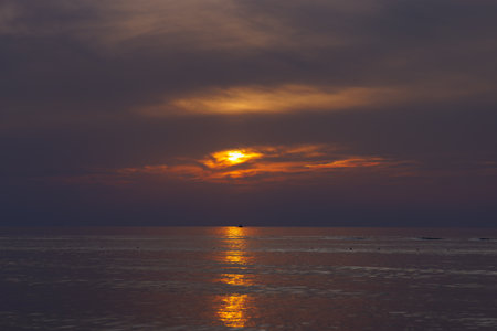 Dusk on the sea and dramatic sky, and sunny pathway.の写真素材