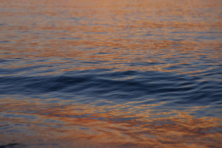 Magical color of the sea waves at sunsetの写真素材