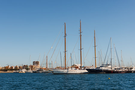 Classic wooden sailing yachts stand in the marina.の写真素材