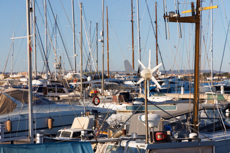 Masts, wind generator, boats in the yacht marina.の写真素材