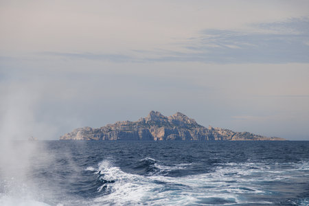 View from the stern of a tourist ship to the island and the wake of the propeller.の写真素材